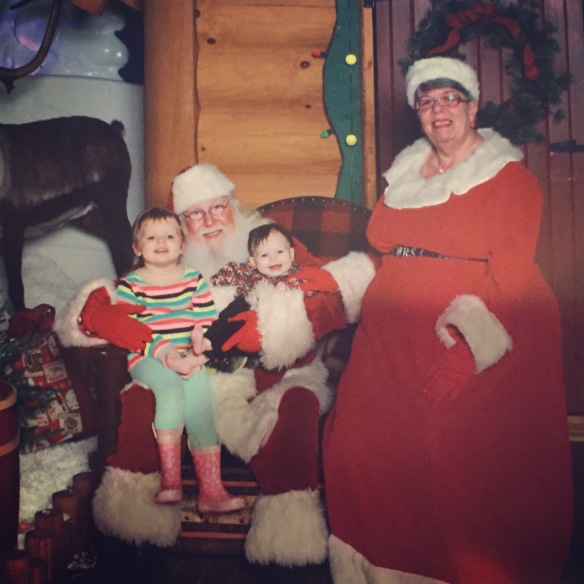 Both girls with Bass Pro Shops Santa and Mrs. Clause